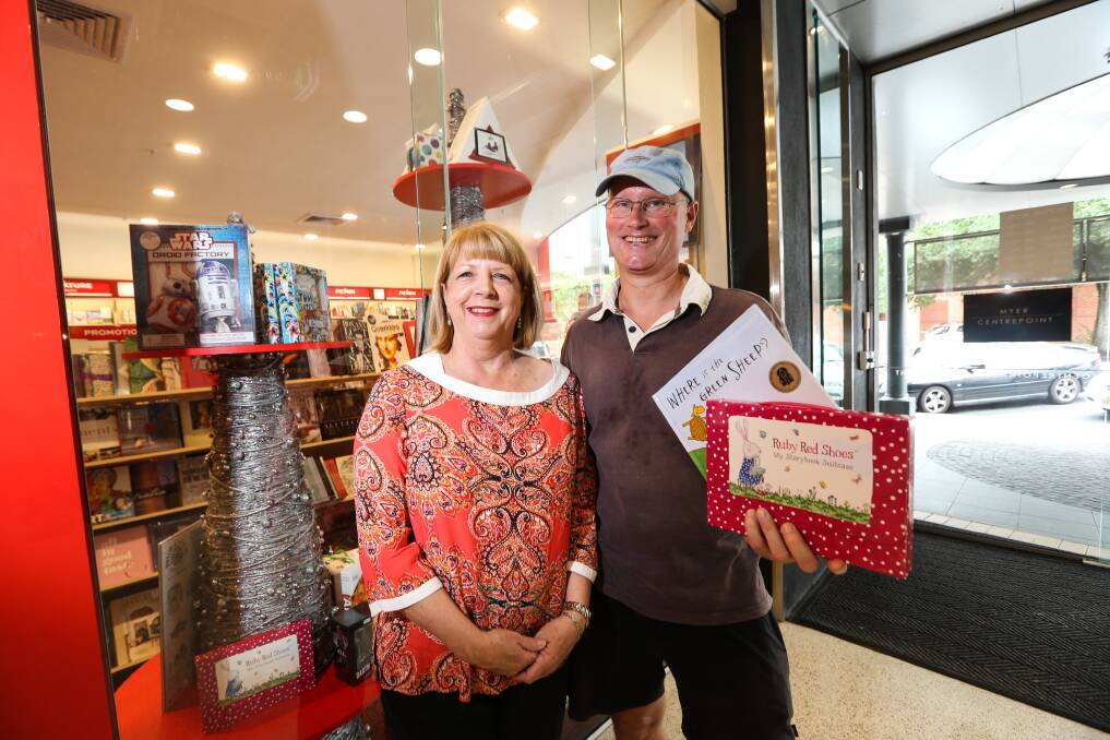 TIME FOR GIVING: Julie and Richard Fenton-Smith from Albury were out buying  books for their grandchildren. Picture: JAMES WILTSHIRE