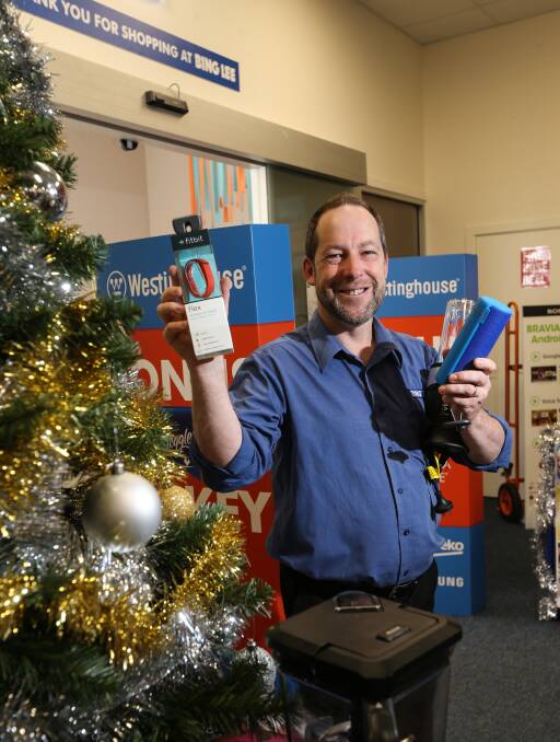 HOT TICKET ITEMS: Bing Lee store manager Peter Trounce with the FitBit, Bluetooth speaker and blender that were selling well in December. Picture: JAMES WILTSHIRE