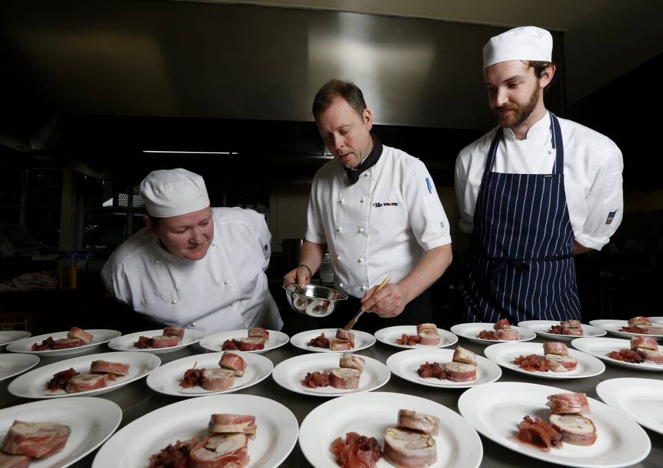 FRENCH CONNECTION: Guest chef Gavin Swalwell plates up the terrine dish for the French Winter Feast as students Kylie Treffers and Lachy Chapman look on.