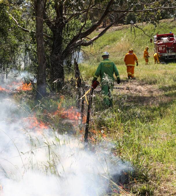 SMOKE SIGNALS: CFA and DELWP staff conduct a controlled burn along Bethanga Creek. The five-hectare burn was to reduce potential fuel ahead of the bushfire season. Picture: JAMES WILTSHIRE