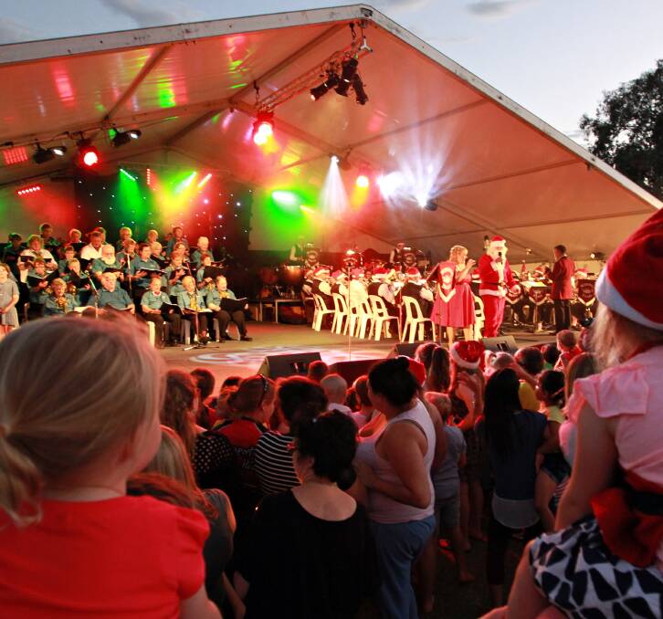 OH CAROLS: Santa makes an appearance at last year's Wodonga Carols By Candlelight. The event returns to Willow Park on Sunday, December 20.