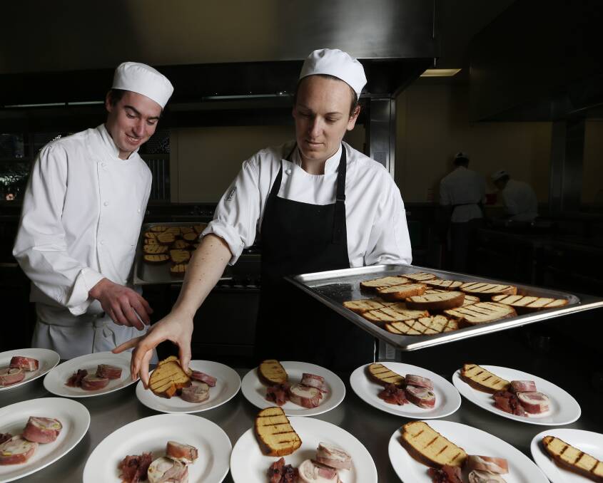 FRENCH FLAIR: TAFE students Shaun Bassett and Rachael Kron plate the terrine of game dish for the French Winter Feast, the first in the Trilogy of Food series open to the public in The Valleys Restaurant. Pictures: MARK JESSER