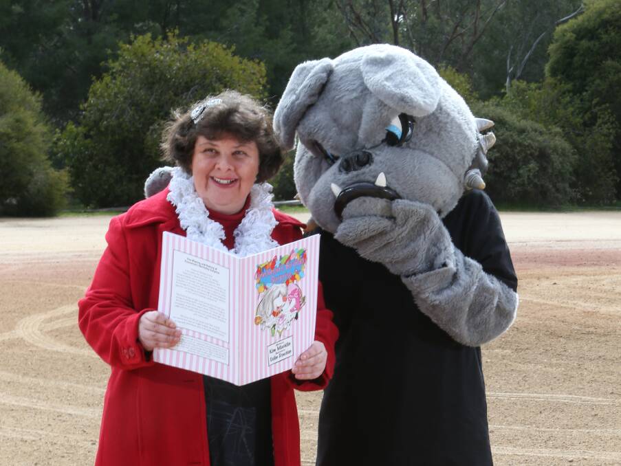 IN THE GOOD BOOKS: Author Kim Macklin reads her second book, Cinnamon's Birthday Surprise, to one of its characters, Brewster, ahead of the launch on Saturday. Picture: ELENOR TEDENBORG 