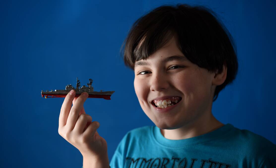 MODEL CHILD: Cootamundra's Taylum Chamberlain, 11, shows off the 'Harry Hill' ship model he entered into the Border Scale Modellers exhibition. Picture: MARK JESSER