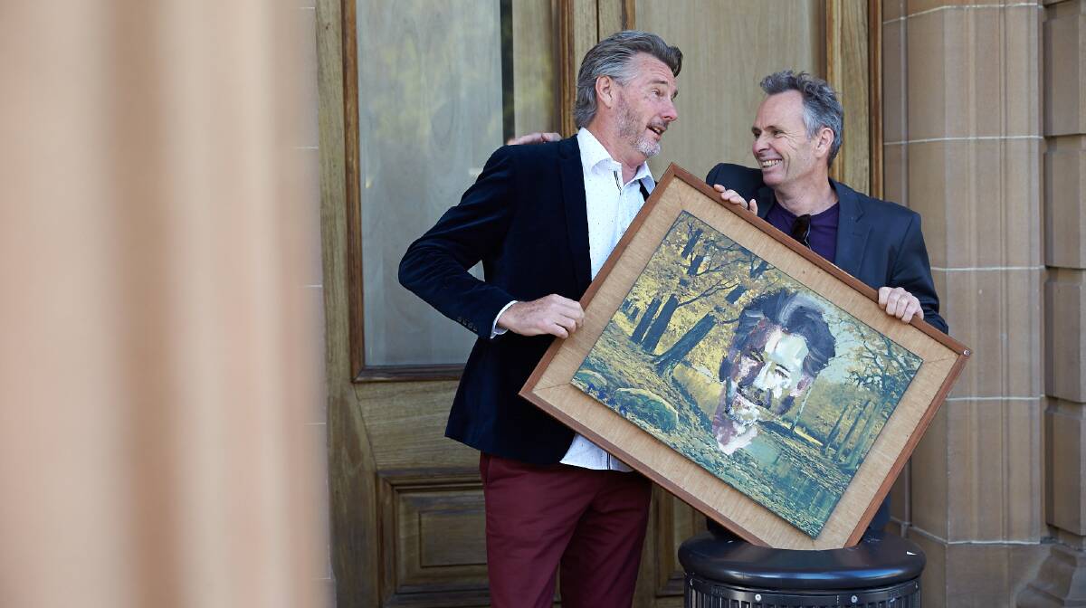 Sustainable: Garage Sale Trail ambassador Barry Du Bois with Archibald finalist Paul Ryan and the portrait he created from a recycled print destined for landfill.