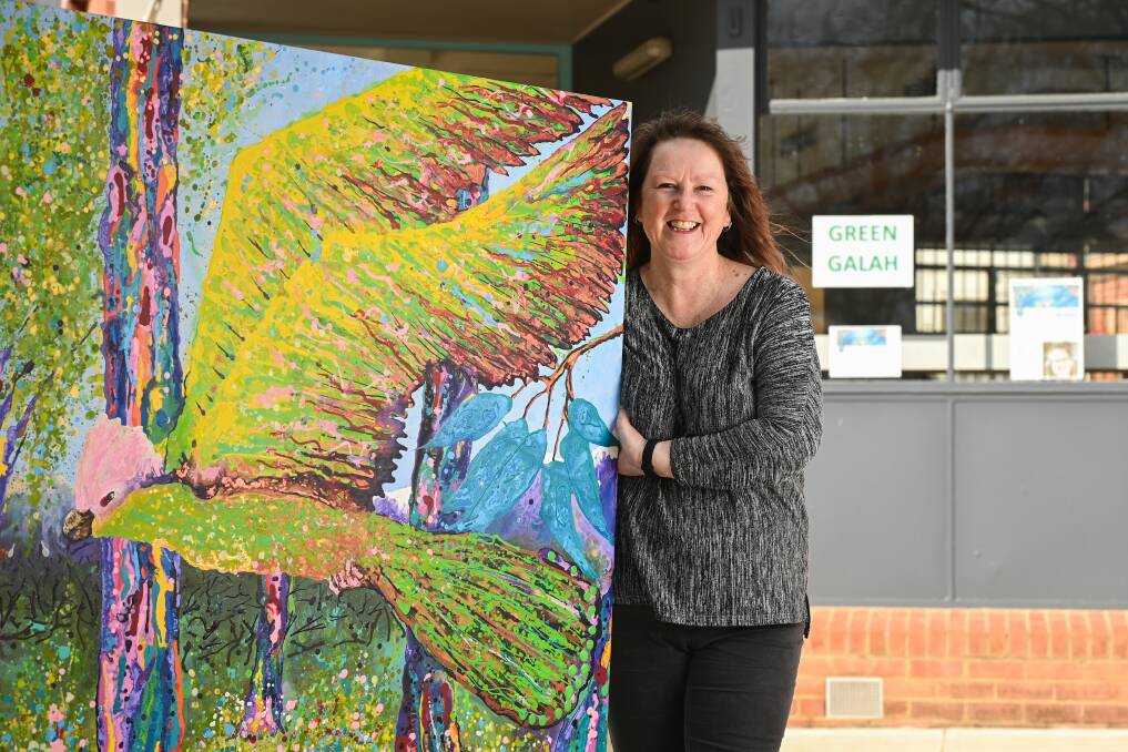 THE ART OF IT: Purple Chicken founder Jen Tait with her latest creation - and the artwork to match it - Green Galah at Yackandandah. Pictures: MARK JESSER