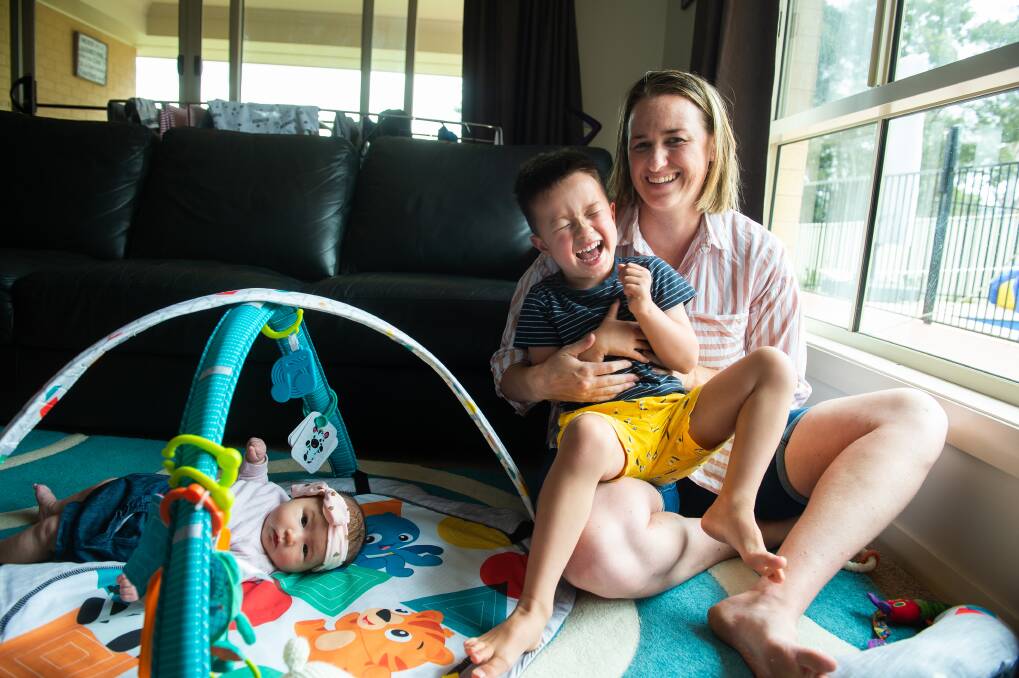 Torey Saisanid, pictured here in 2019 with her children Ari, 4 and Mischa, 3 months, experienced post-natal depression with her first child and now helps other people on the end of the line for Lifeline. Pictures by Mark Jesser