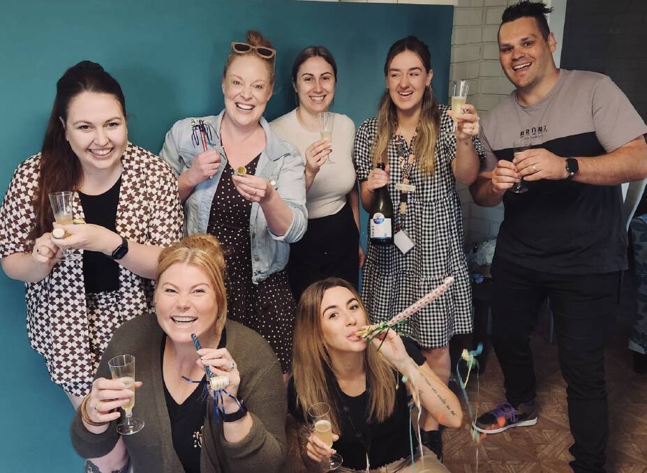 The Yes Unlimited team celebrates the budget announcement on Tuesday morning ... (at back) Hannah Clayton, Kate McGrath, Jelena Keljin, Maggie Pain, Jon Park and (front) Tam Quinn, Josie Daly. Picture supplied
