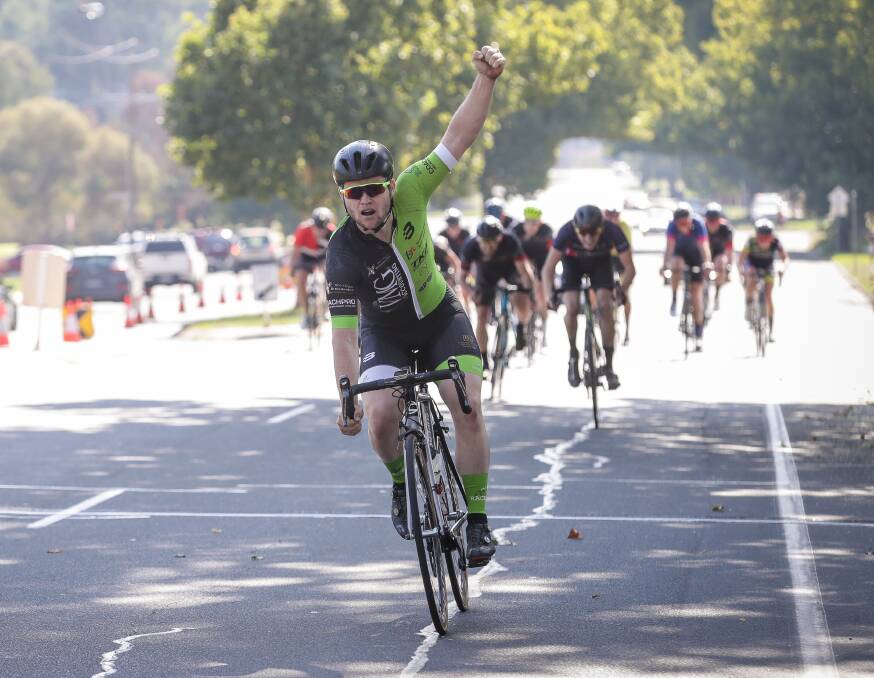 Castlemaine rider Jade Maddern salutes to the crowd after crossing the line in the 2019 John Woodman Cycle Classic in Lavington.