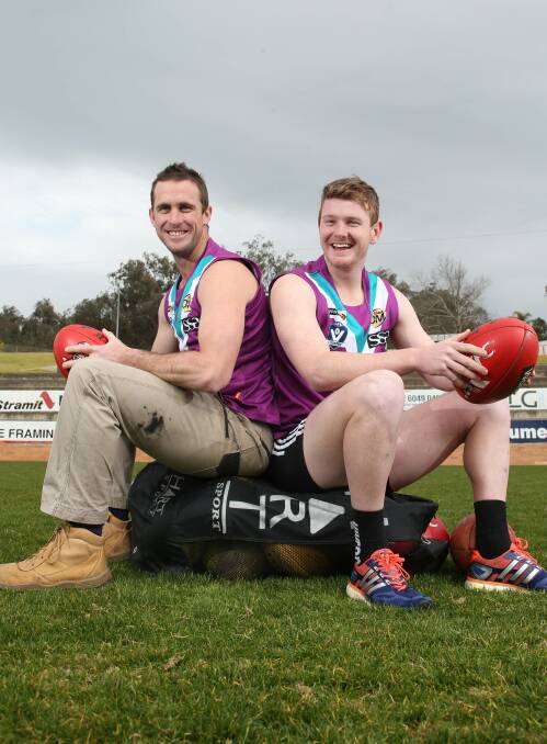 TURNING PURPLE: Luke Garland and Zac Hopper show off the jumpers Lavington will wear against Wangaratta Rovers at Lavington Oval on Saturday. Picture: ELENOR TEDENBORG