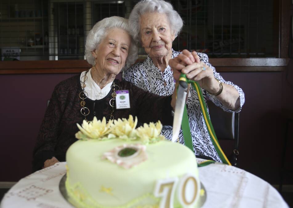 HAPPY ANNIVERSARY: Life members,  Maisie Putnings, 86, and Lorna Crago, 99, celebrating 70 years of Tallangatta CWA. Picture: ELENOR TEDENBORG