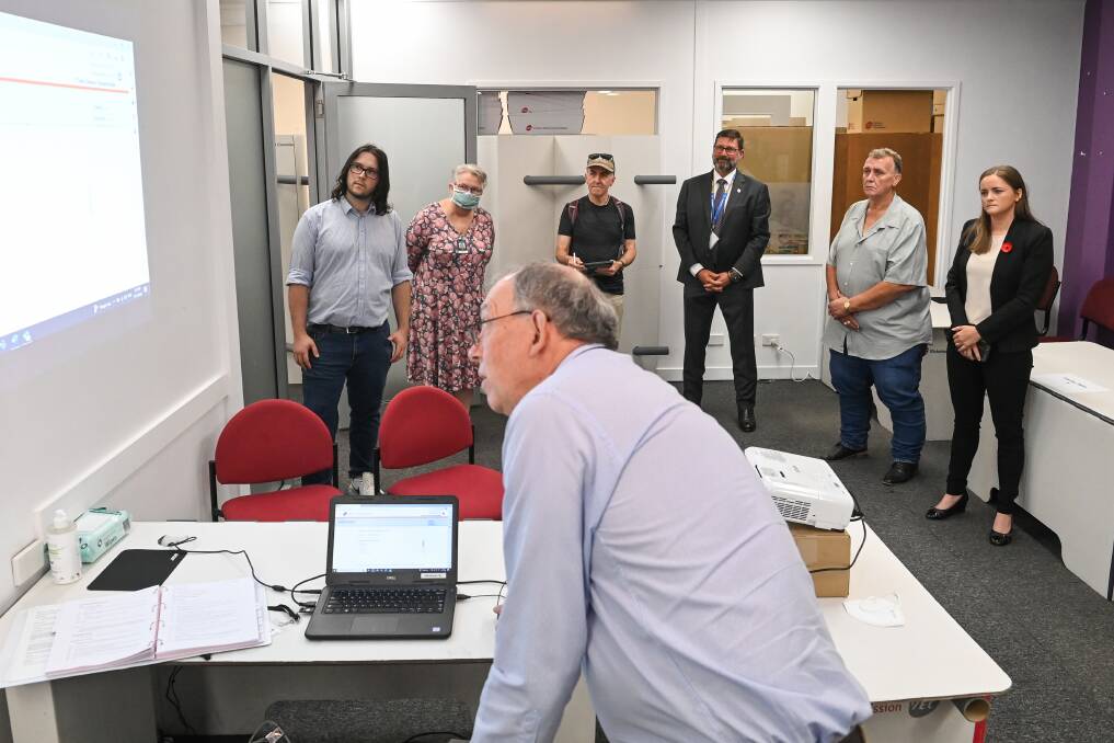 Candidates watch the screen as Benambra election manager Trevor Deacon conducts the ballot draw on Friday afternoon for this month's poll. Picture by Mark Jesser.