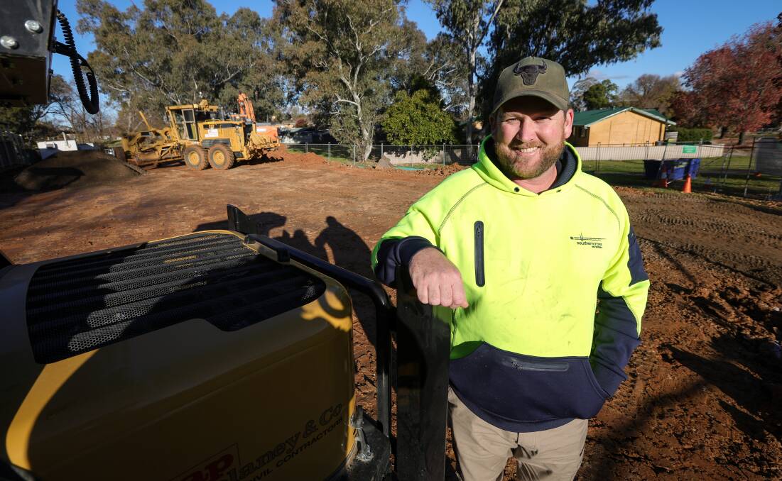 Building site manager Fletcher McKenzie, of Southern Cross Developers, stands on the soil base that has been built up to allow for the expansion of Albury Preschool. Picture by James Wiltshire