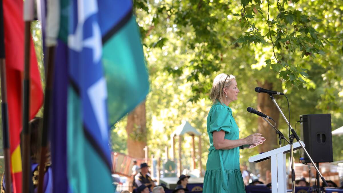 Farrer MP Sussan Ley participates in the 2023 Australia Day citizenship ceremony at Albury's Noreuil Park with the Aboriginal, Australian and Torres Strait Islander flags in the foreground. Picture by James Wiltshire