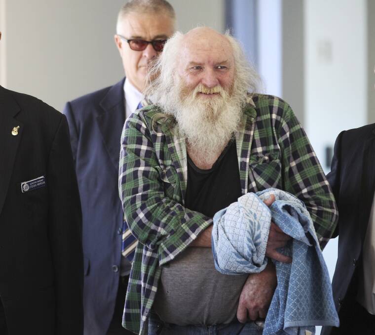 Free to go: Colin Michael Newey walks through Sydney airport after his arrest last year.