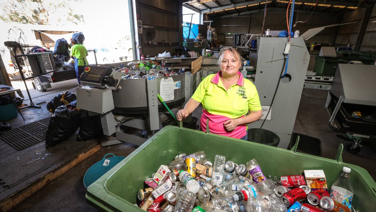 Heather Groesch in front of the machine which whizzes through the scanning of bottles and cans and sorts them into different sizes and colours. Picture by James Wiltshire
