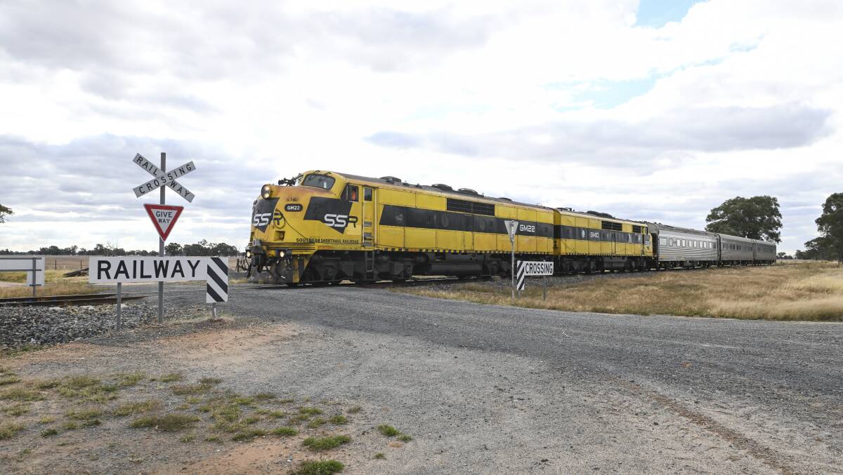 A test train monitoring the state of the Benalla to Yarrawonga line navigates a crossing on the line during a run in April. Concern about people gathering at such locations has prompted a 25kmh speed for heritage runs in June. Picture by Mark Jesser