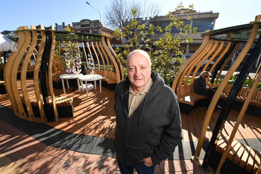 Proud: Garry Rutland with his work in Dean Street which has hoop pine marine ply fins leading to steel roofs bearing the Albury Council logo. It was designed by Melbourne-founded landscape architecture firm TCL. Picture: MARK JESSER