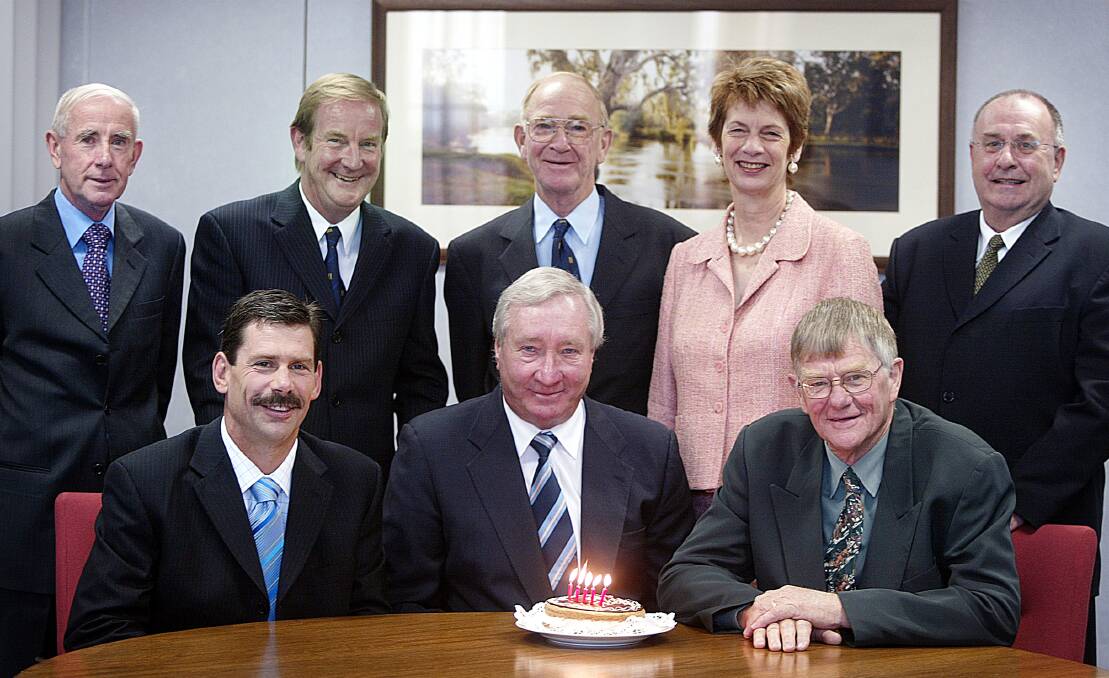 Lou Lieberman behind a cake to mark the 50th anniversary of the Hume Building Society in 2005 with fellow board members (from left) Bill Hanrahan, Andrew Saxby, Ulf Ericson, Les Boyes, Joy Stocker, John Knobel and Leo O'Reilly.