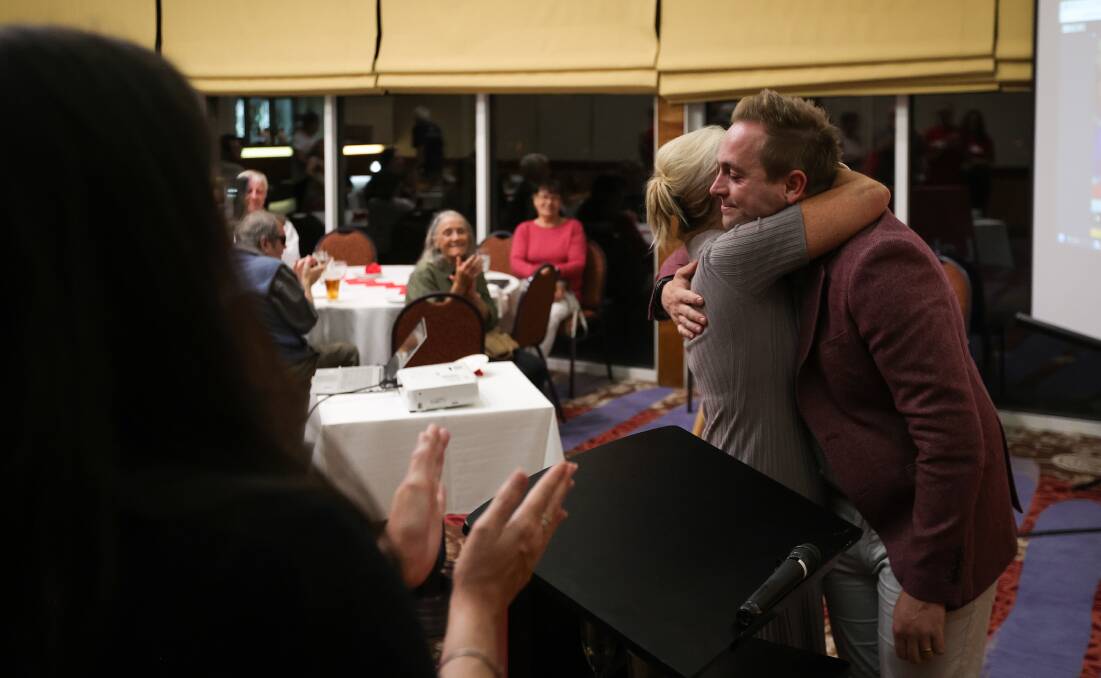Labor candidate for Albury Marcus Rowland is hugged by his mother Claudia Rowland after addressing his supporters at the Thurgoona Golf Club. 