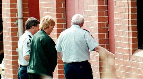 Graham Mailes is led into Albury Court by security personnel in 1996 after being charged with the murder of Kim Meredith.