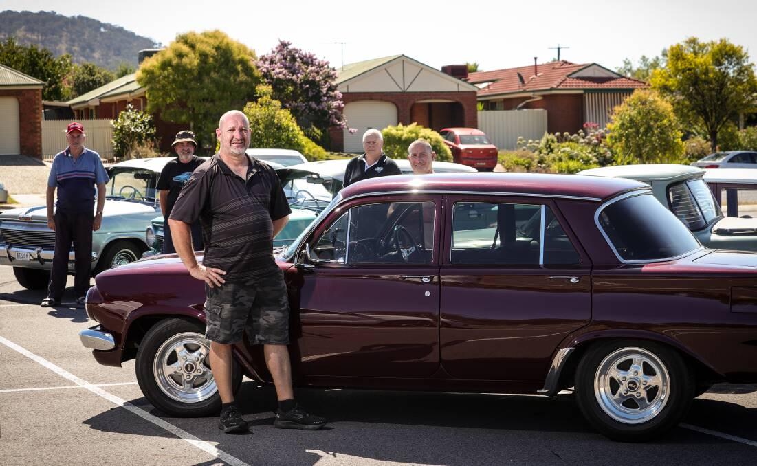 Holden owner Shannon Koschel stands in front with his EJ as fellow fans of the marque Rob Beasley, Dave Clark, Kerry Bedford and Pat Harding watch on with their vehicles. Picture by James Wiltshire