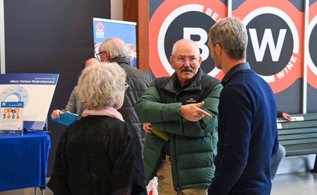 Wodonga mayor Ron Mildren speaks to interested citizens at a consultation session held at his city's White Box Rise shopping centre earlier this year about plans for a revamped Albury hospital.