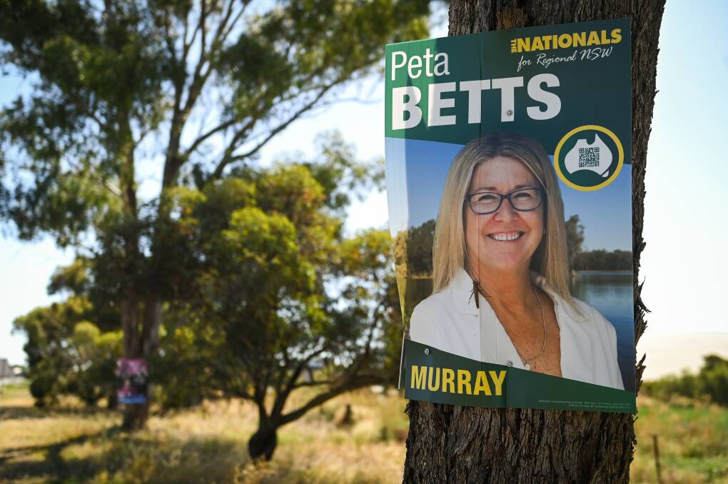 An election poster for Peta Betts on a tree alongside the Riverina Highway earlier this year. A pink-toned sign supporting incumbent Helen Dalton is on a gum in the background. Picture by Mark Jesser