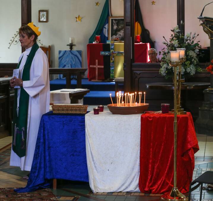 Flames for the French: Candles were lit at Albury St Matthew's Anglican Church to honour those killed by Muslim extremists in Paris.