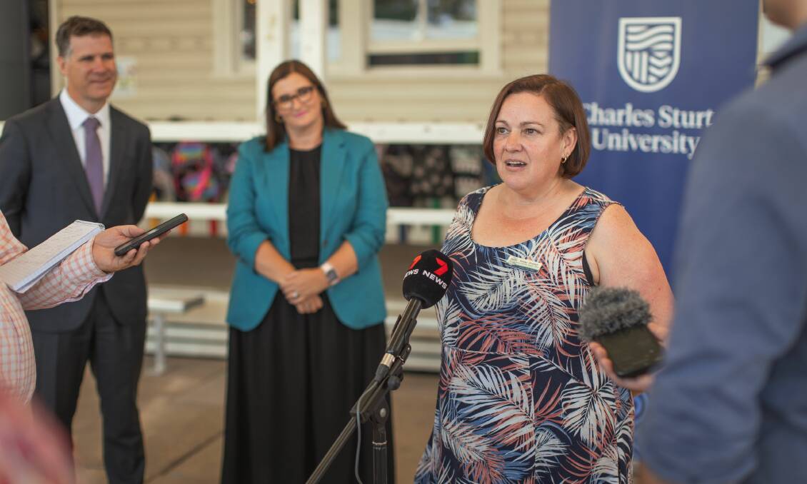 Student support officer Kathy Scanlon speaks to the media at Lavington Public on Tuesday as Albury MP Justin Clancy and Education Minister Sarah Mitchell watch on. Picture from Charles Sturt University.