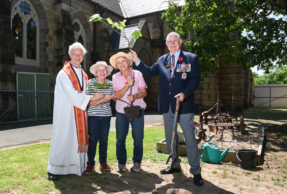 Father MacLeod-Miler joins church gardeners Betty Loorham and Robyn Gibbs and RSL president Graham Docksey in planting the fig tree on Saturday. Picture by Mark Jesser