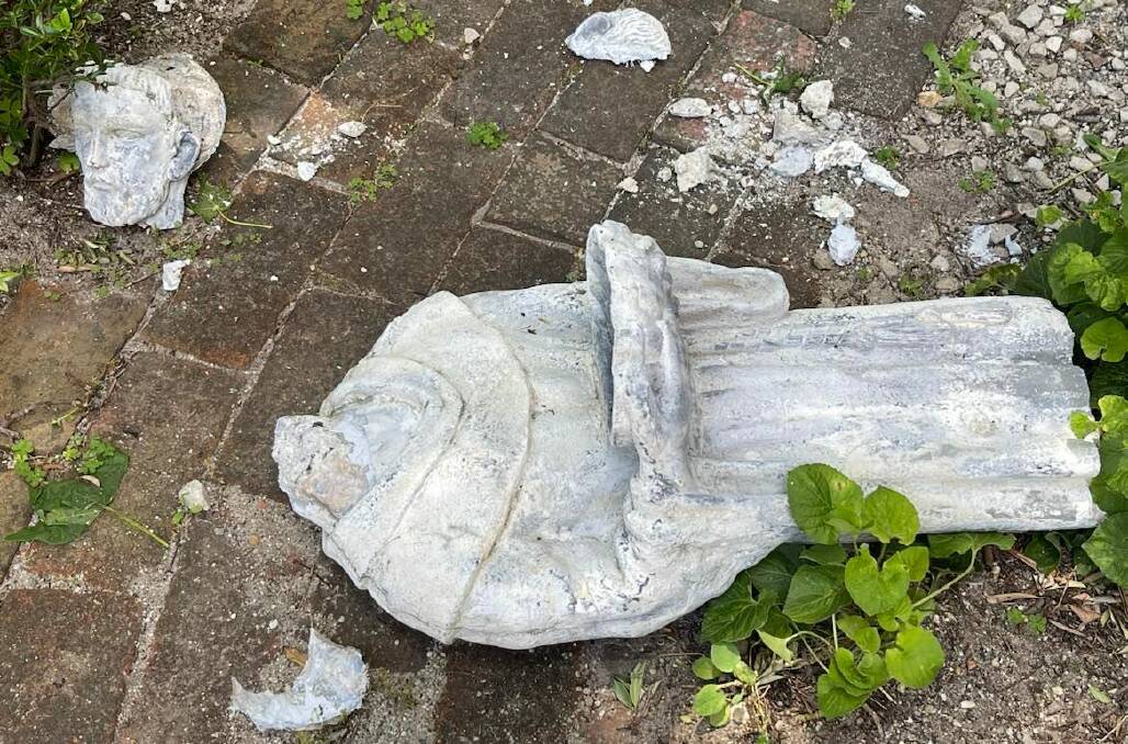 The body of the statue of St Francis of Assisi lies on the ground after being toppled from its base