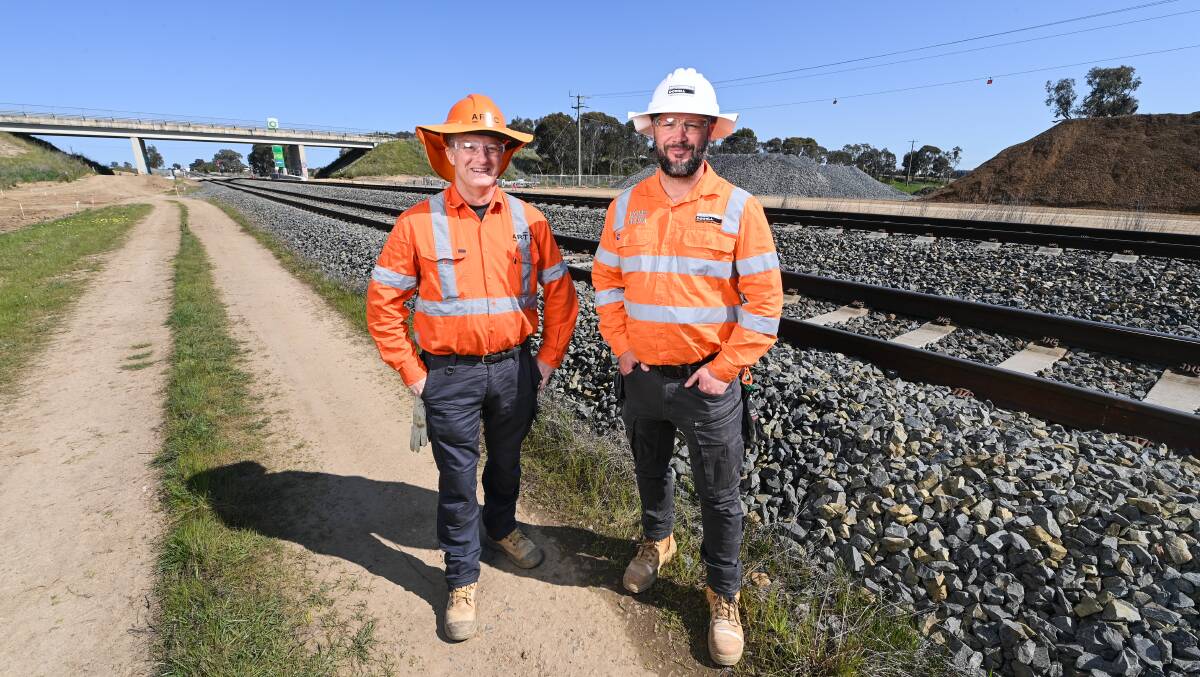 ARTC project director Matthew Hart and McConnell Dowell rail project superintendent Dan Bonnitcha at Barnawartha North where the track will be lowered and ballast and fill in the background used to remount the rails. Picture by Mark Jesser