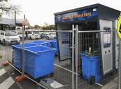 The drink container deposit machine being installed in the car park of Wodonga Plaza, with the shopping centre's eastern entrance in the background. Picture by Mark Jesser