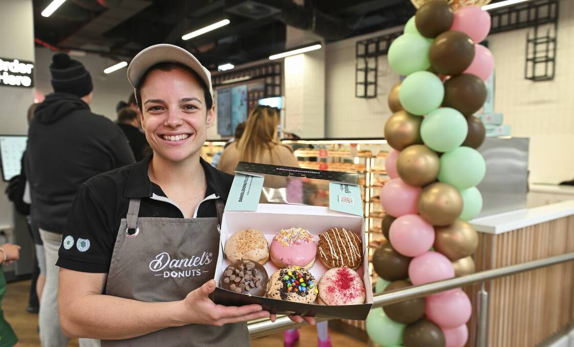 Area manager Ash Bratby with some of the donuts being sold at the new store which has opened after an extensive renovation of the former bank. Picture by Mark Jesser 