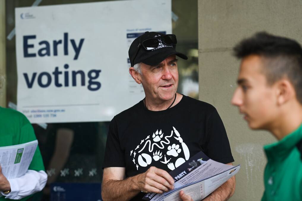 Mike Fuery hands out how-to-vote brochures for the Animal Justice Party. Picture by Mark Jesser