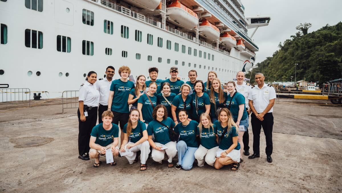 Hello sailors: The Rotary delegation from the Border with cruise ship crew members in front of the Pacific Adventure in Port Vila, before their voyage home. Picture supplied