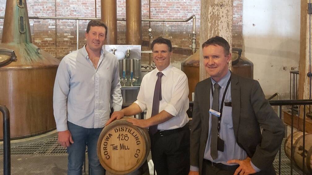 Roll out the barrels: Dean Druce and Justin Clancy with Federation Council general manager Adrian Butler at the Corowa whisky and chocolate factory.