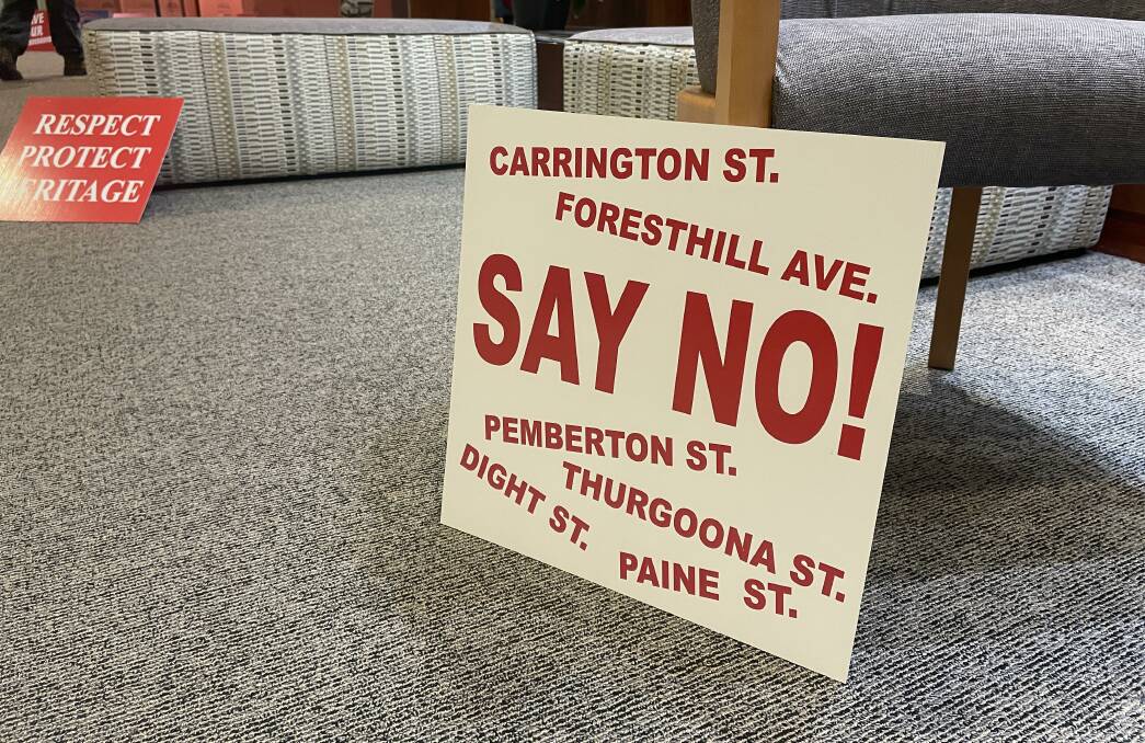 Residents who live nearby the planned six-storey development on the western edge of the Albury CBD put out signs in the council foyer urging councillors to reject the development on Monday night.