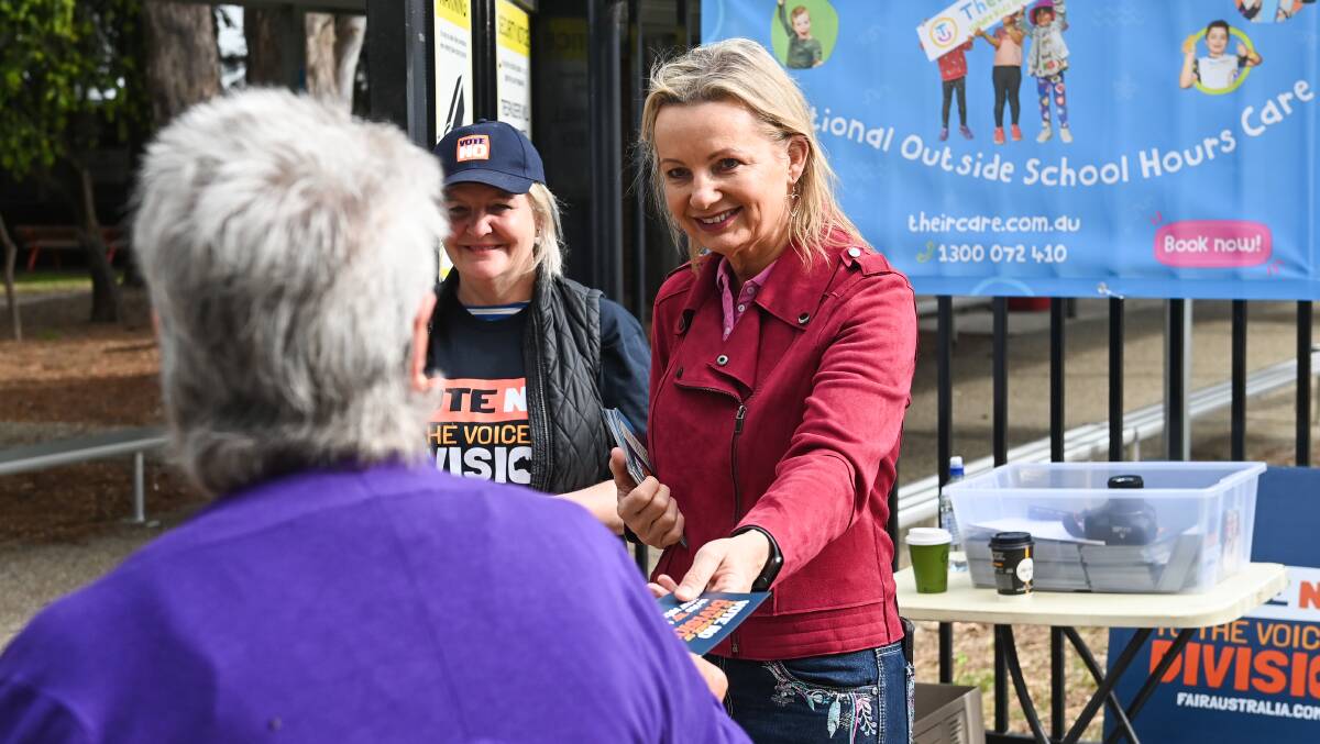 Sussan Ley hands a no vote flyer to a decision-maker entering the Lavington East Public School polling booth on Saturday morning. Picture by Mark Jesser