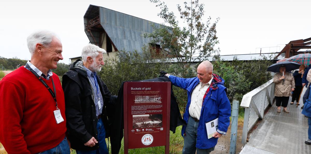 Engineering feat: Carl Doring, Geoff Hayes and Parks Victoria's Andrew McDougall unveil the marker at Eldorado's dredge. Picture: MARK JESSER