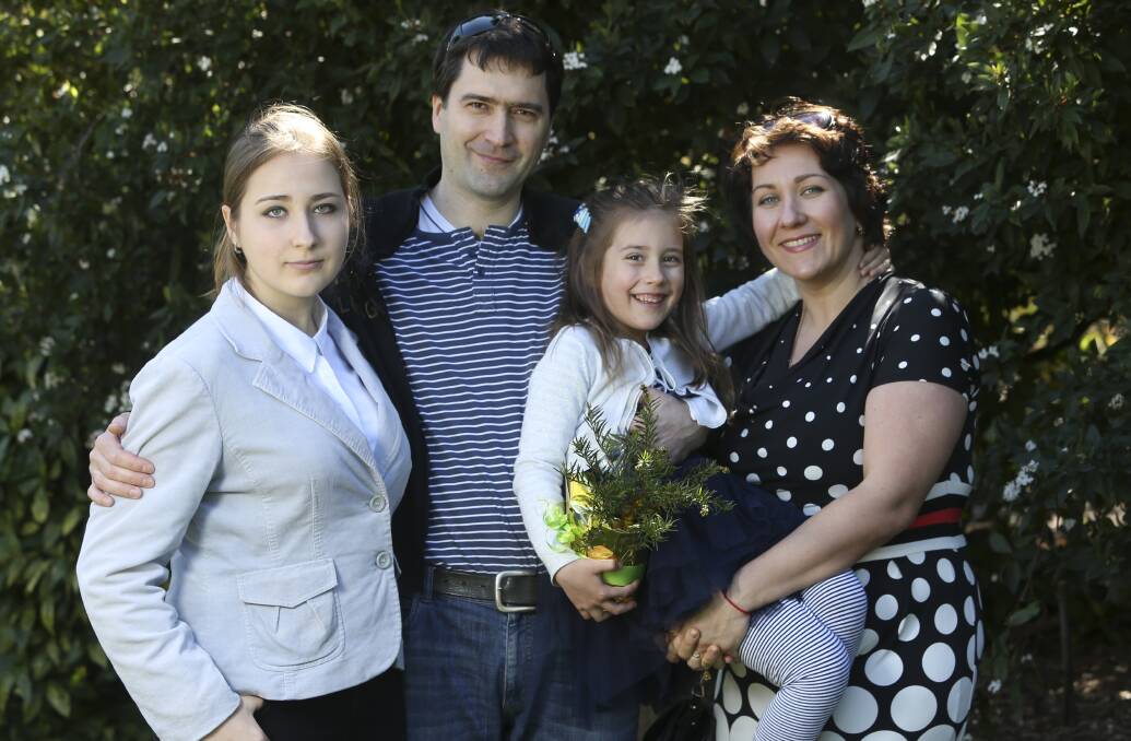 New life: The Bagayev family - Mariya, 15, father Oleksandr, Yuliya, 5, and mother Tetyana after their naturalisation at the Albury Botanic Gardens.