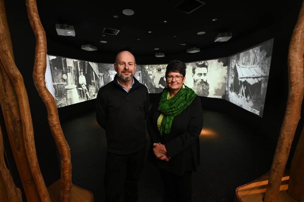 Kelly Gang descendants Anthony Griffiths and Noeleen Lloyd inside the Ned Kelly Discovery Hub in front of video screens that tell the story of the region. Picture by Mark Jesser