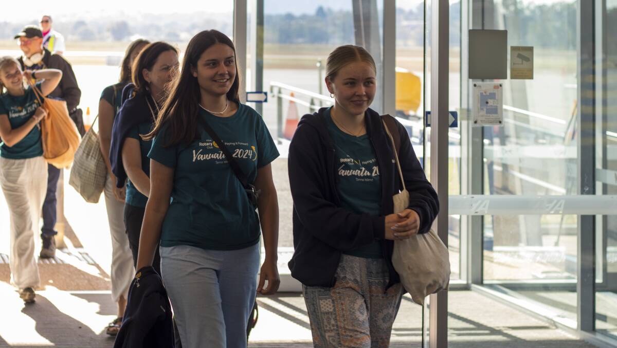 Volunteer helpers Rose Menager and Alicia Butler arrive at Albury airport. The latter celebrated her 22nd birthday on the cruise across the South Pacific. Picture by Layton Holley