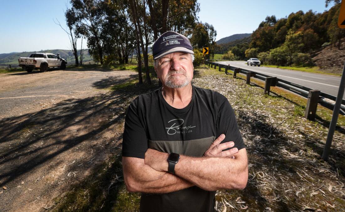 Alex Wolf stands near the Beechworth-Wodonga Road up the hill from the turn-off to Yackandandah. The rest area he is standing in overlooks his property and has been the launch area for tyres thrown on to his farm. Picture by James Wiltshire