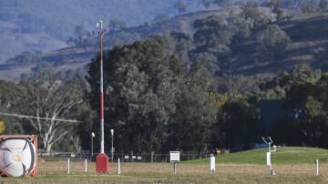 The automated weather station at Albury airport looking west. It includes an anemometer marked by its red and silver post, and a white box, known as a Stevenson screen which contains measuring instruments. Picture by Mark Jesser