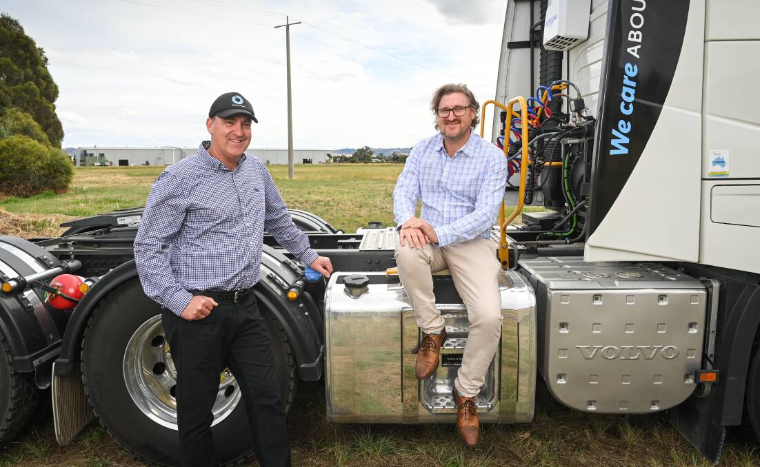 Mark and Dean O'Brien with one of the 50 prime movers based in South Albury that will now move to the land in the background that will become home to the brothers' haulage business. Picture by Mark Jesser