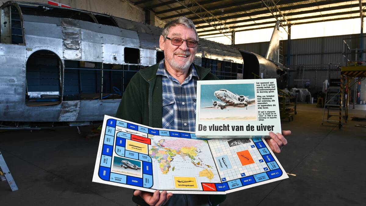 Russ Jacob with an Uiver board game which follows the air race route with an Albury stopping point part of the game. It was produced in the 1980s to mark the 50th anniversary of the London to Melbourne contest. Picture by Mark Jesser