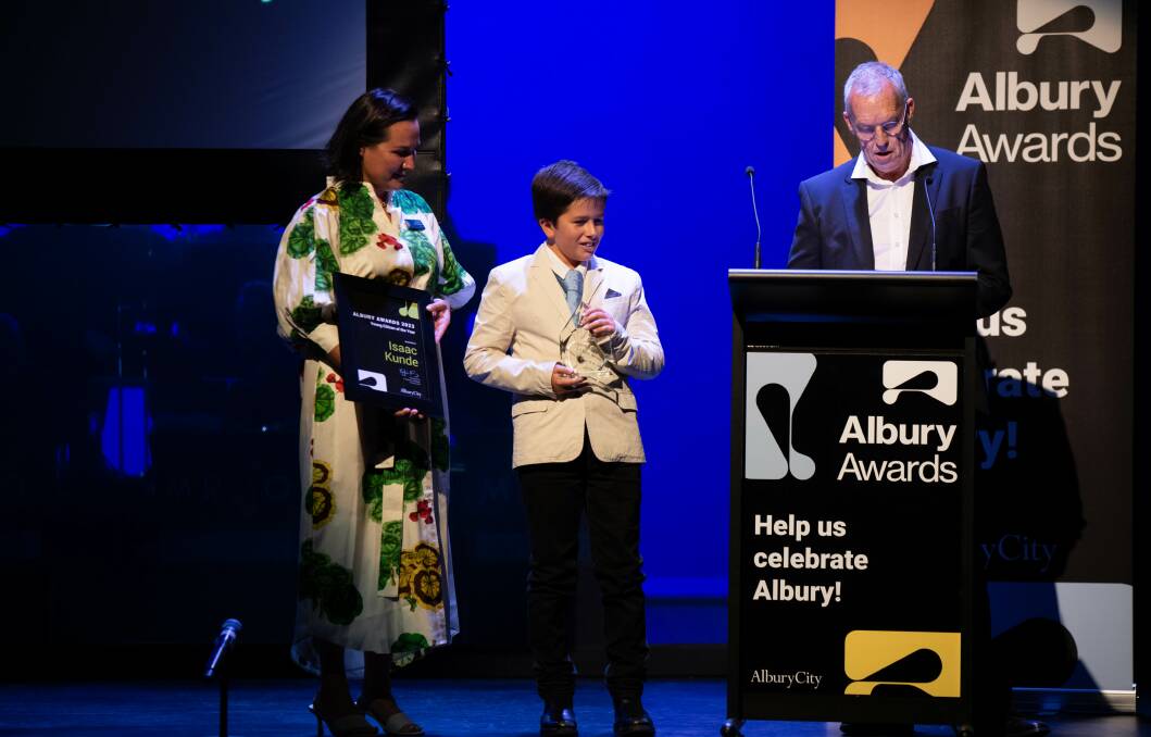 Young citizen of the year Isaac Kunde listens along with councillor Jess Kellahan as her colleague Stuart Baker reads out the 11 year-old's achievements. Picture by Tara Trewhella