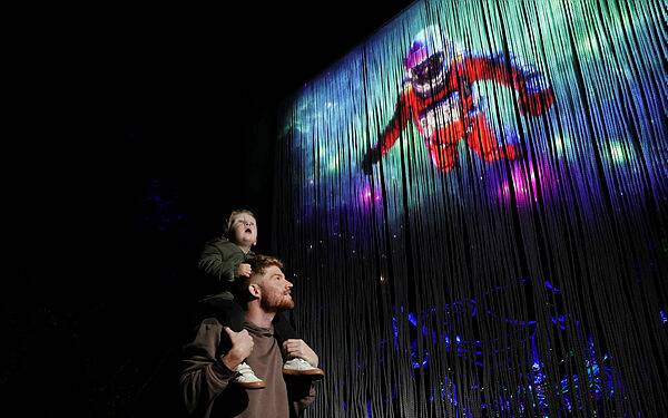 Travis Marshall and his son Vann, 2, were left dazzled by the illuminated image of an astronaut which is key part of the latest Aurora show coming to Albury's Botanic Gardens. Picture from Illawarra Mercury